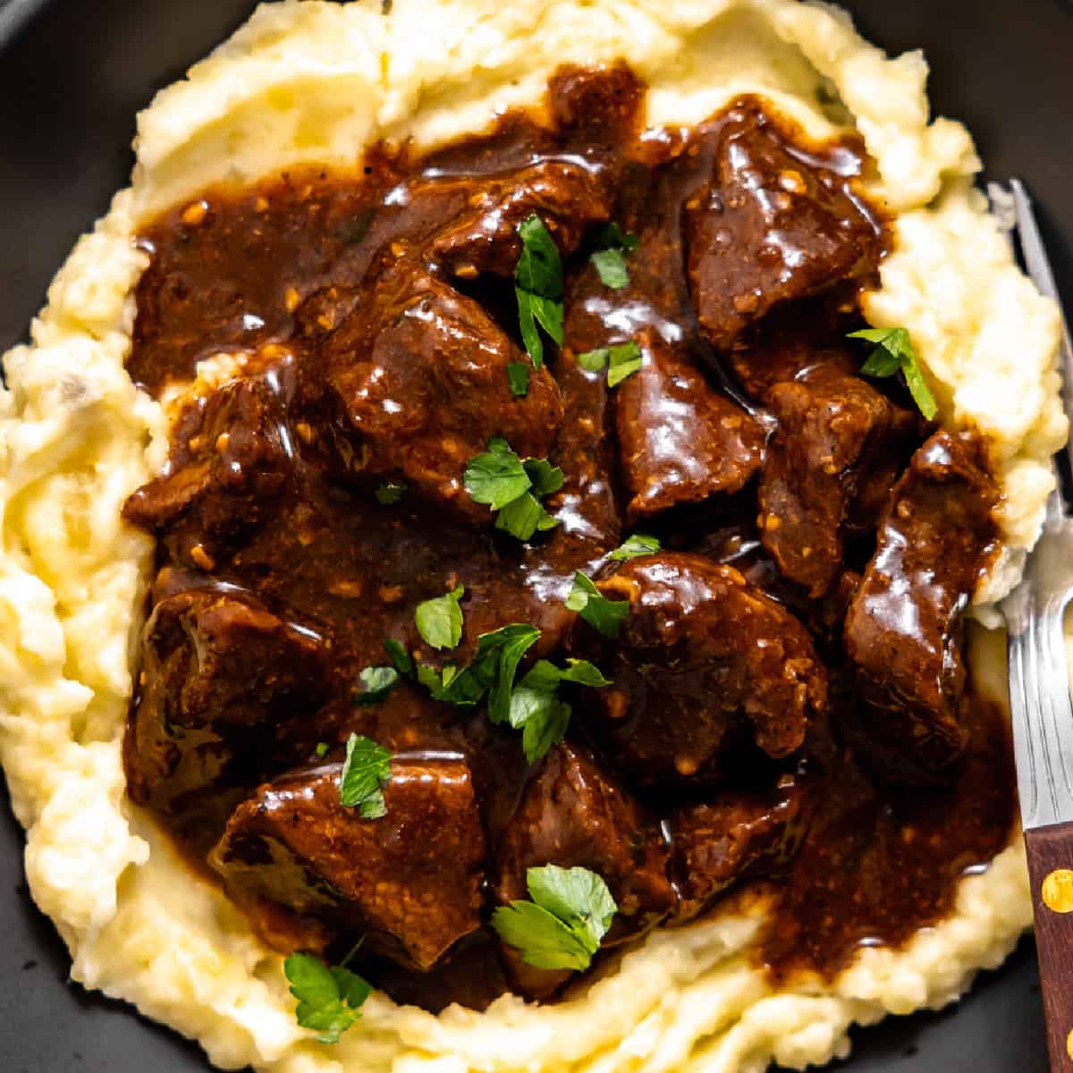 Beef tips and gravy served over mashed potatoes.