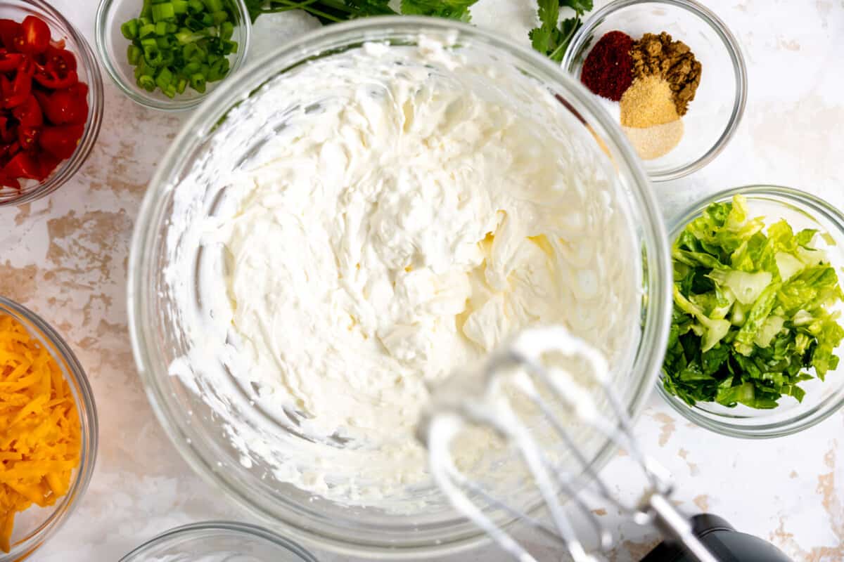 Cream cheese and sour cream mixed with hand mixer.