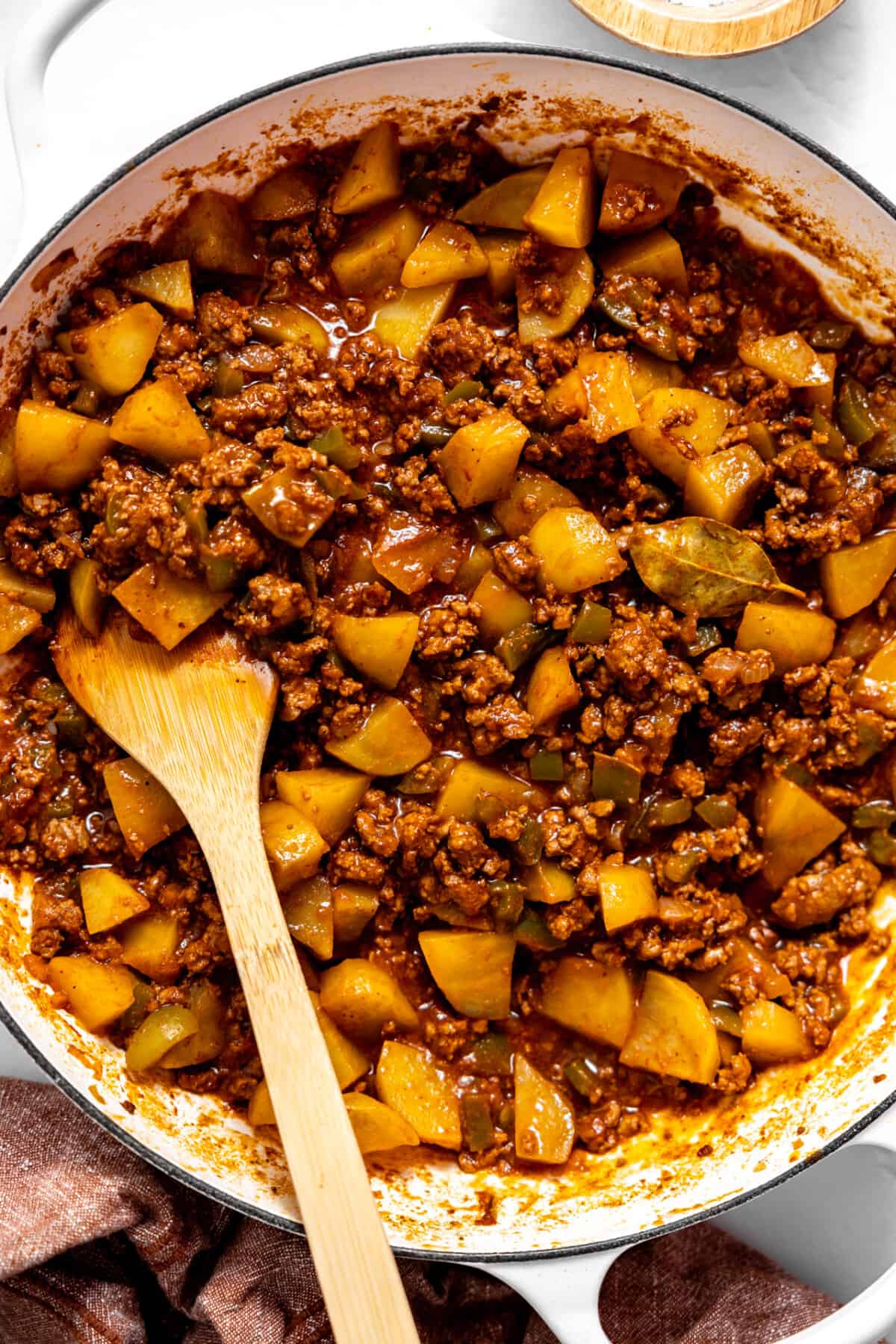 Skillet filled with Mexican picadillo.