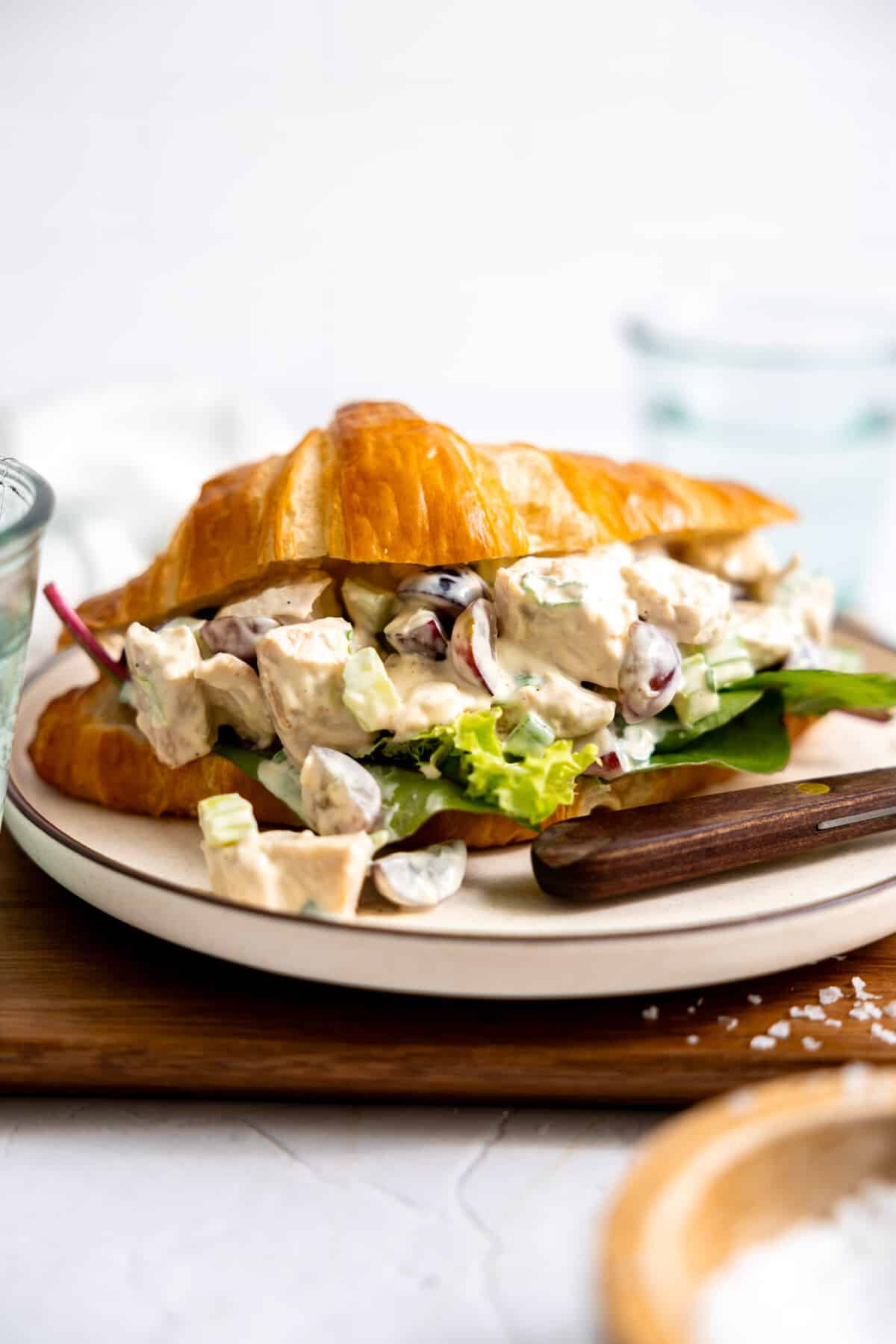 Chicken salad served on a croissant for a sandwich. 