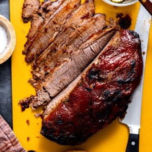 Sliced beef brisket on a cutting board.