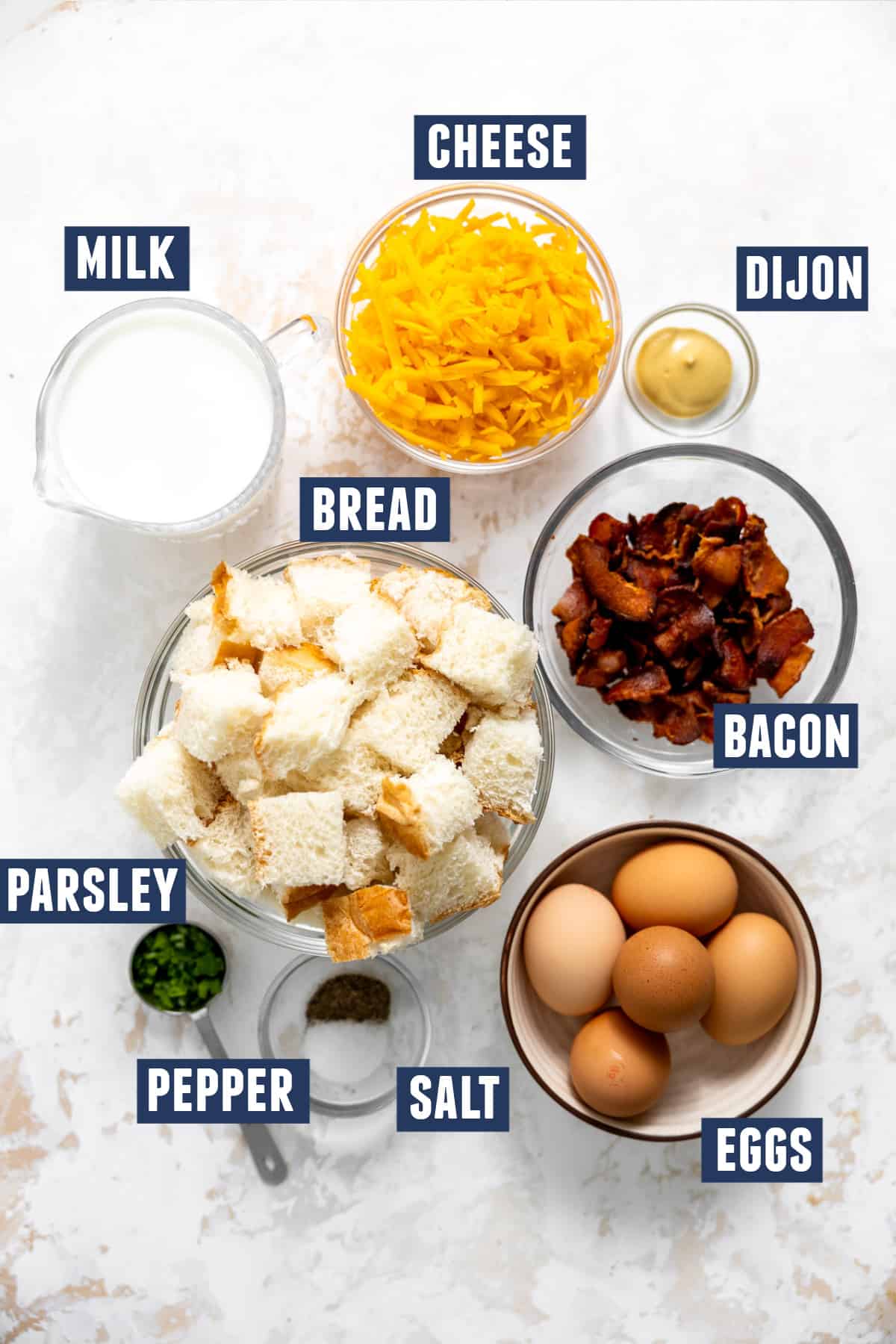 Ingredients needed to make a bacon and cheese strata. 