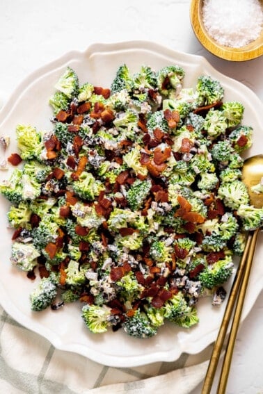 Broccoli salad topped with bacon served on a plate.