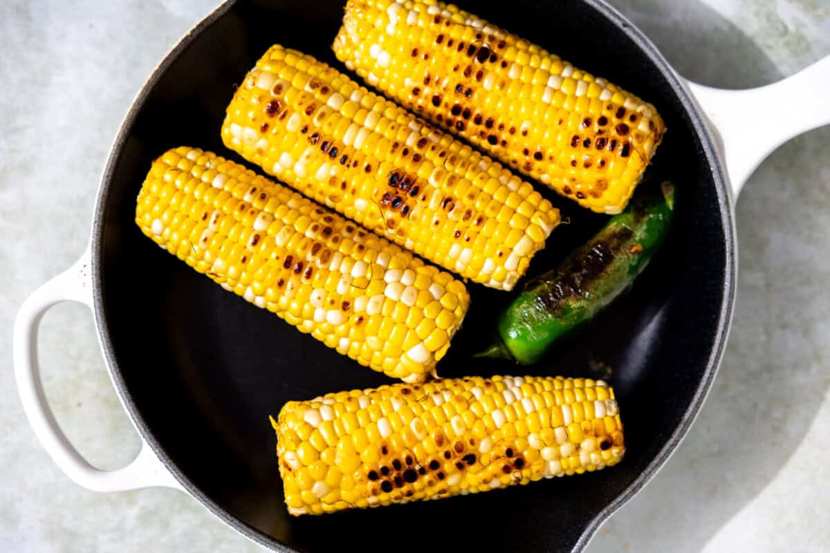 Cast iron skillet with roasted corn and jalapeno. 