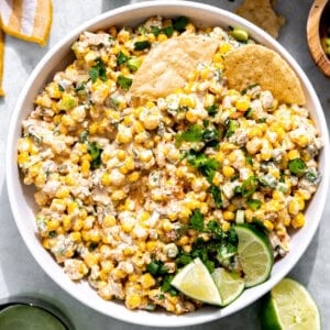 Bowl of Mexican Corn Dip served with tortilla chips.