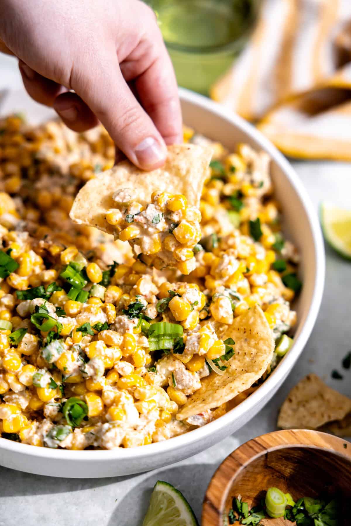 Scooping up Mexican Corn Dip with a tortilla chip.