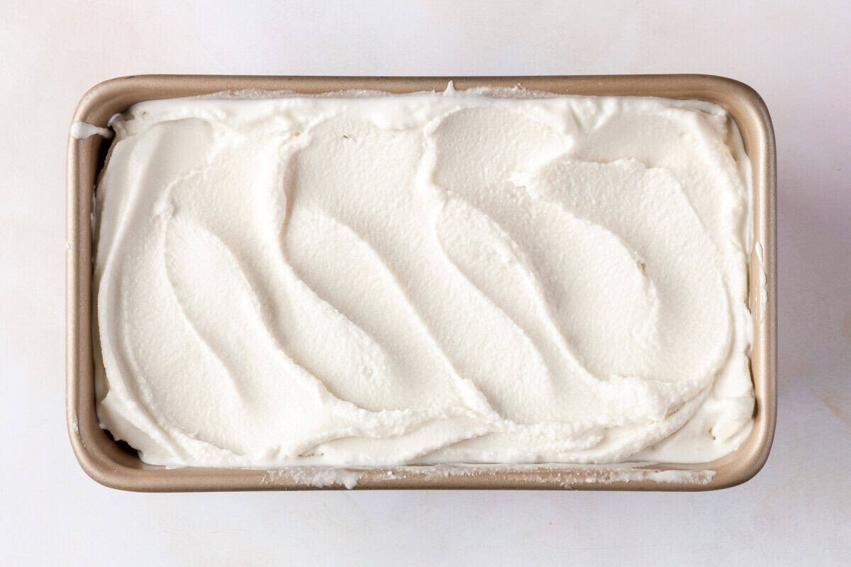 Coconut sorbet spread into a loaf pan before freezing.