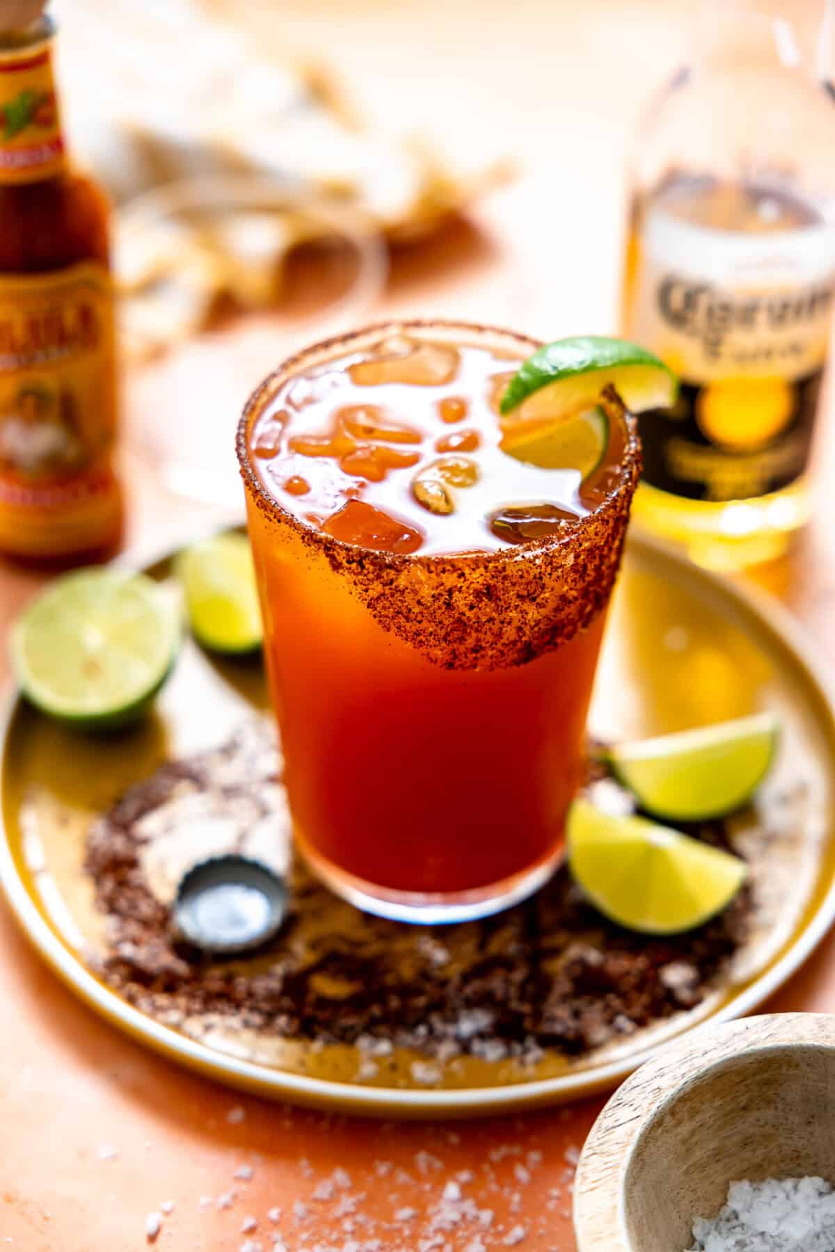 Michelada served with lime wedges.