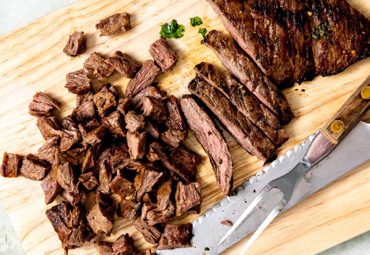 Chopped carne asada on a wooden board. 