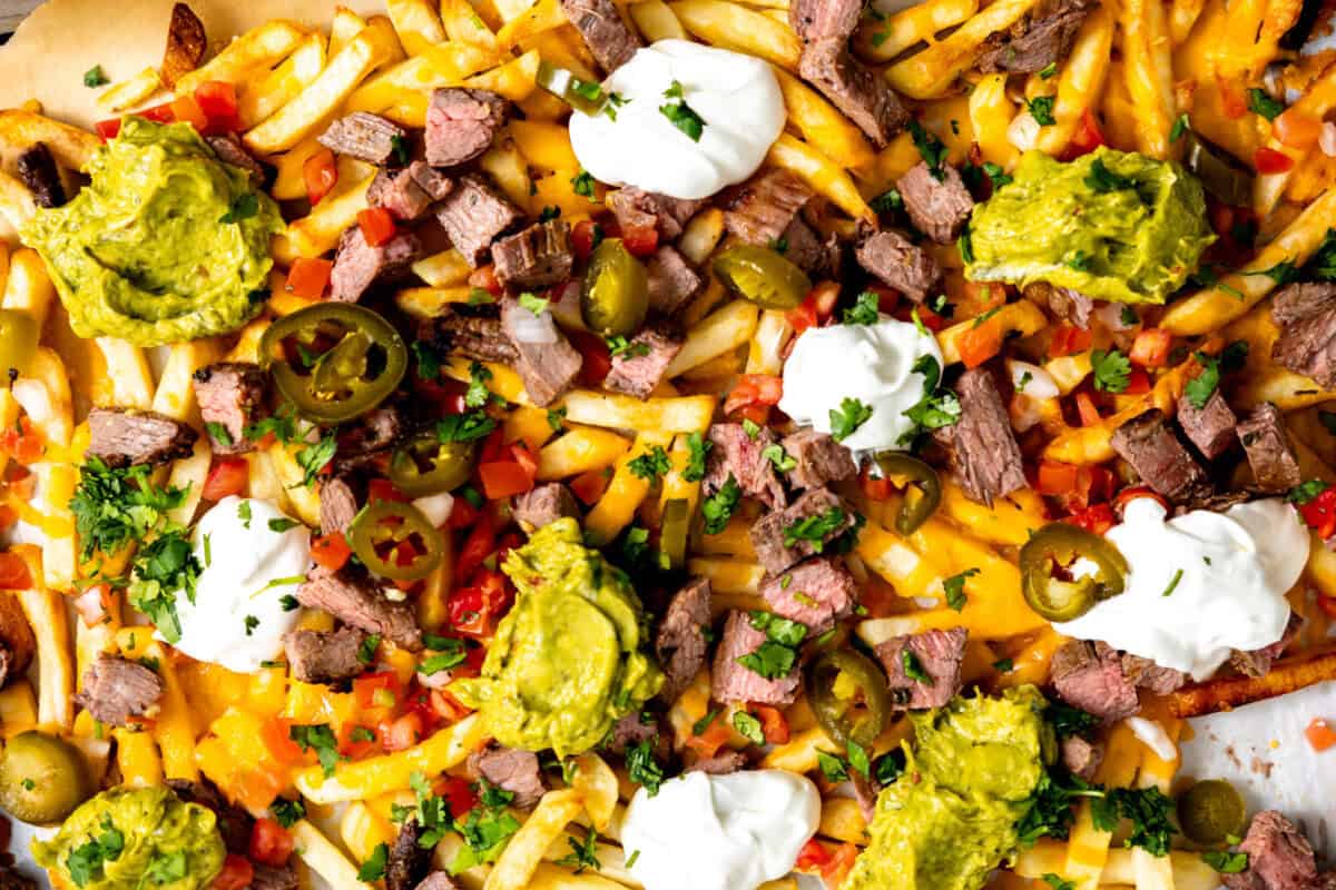 Carne Asada fries topped with sour cream and guacamole. 