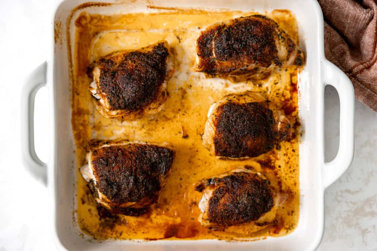 Chicken thighs in a baking dish after being baked.