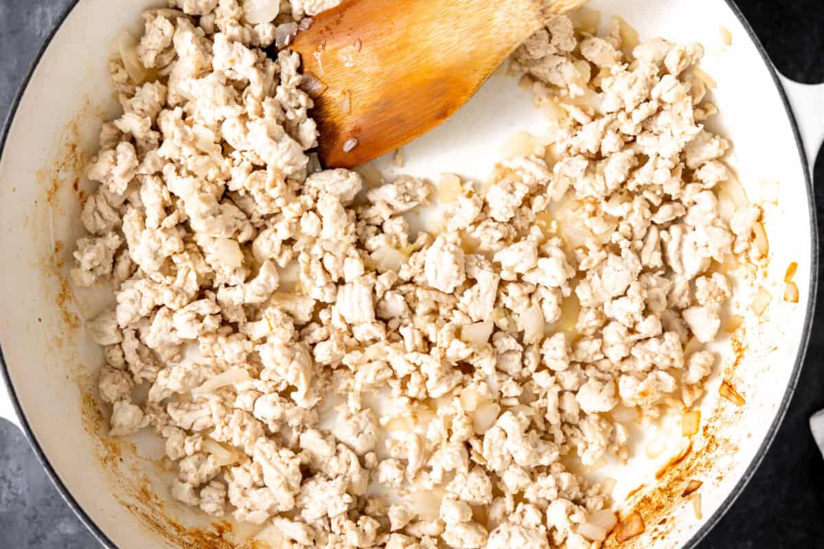 Cooking ground turkey and onion in a skillet. 