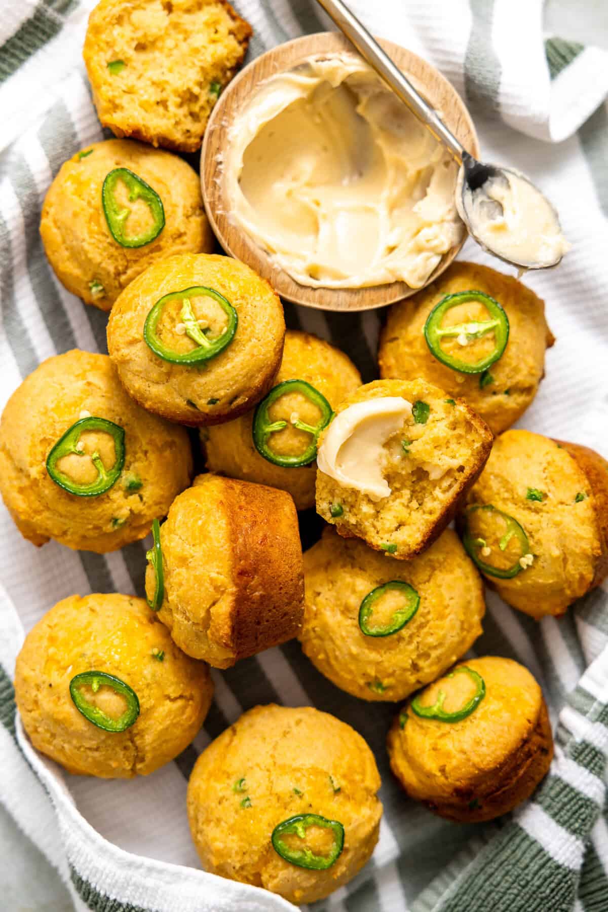 Tray filled with baked Jalapeno cornbread with a bowl of homemade honey butter to slather on while warm. 