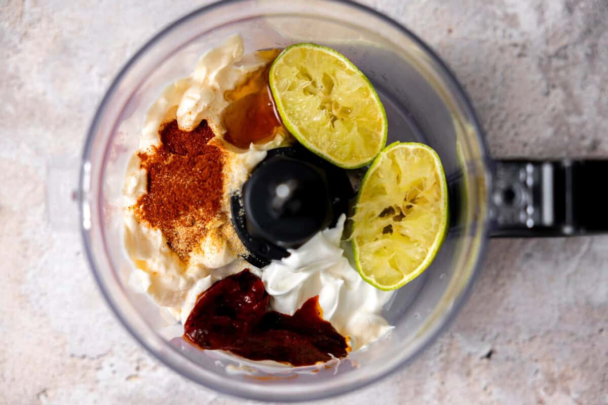 Ingredients to make chipotle mayo in a food processor. 