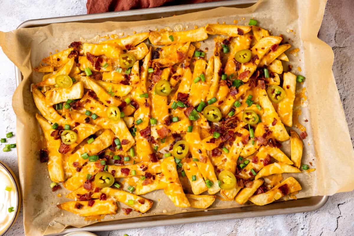 Crispy French Fries topped with melty cheese and bacon then topped with fresh green onion. 