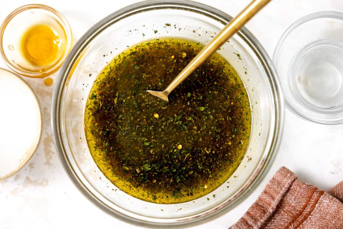 Ingredients for Italian Dressing in a cup after mixing together. 