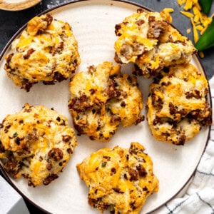 Sausage and cheese drop biscuits on a plate.