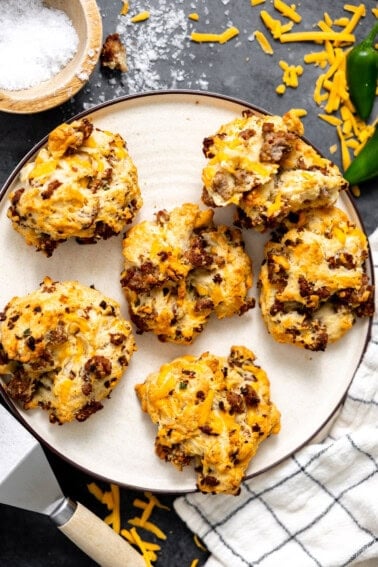 Sausage and cheese drop biscuits on a plate.