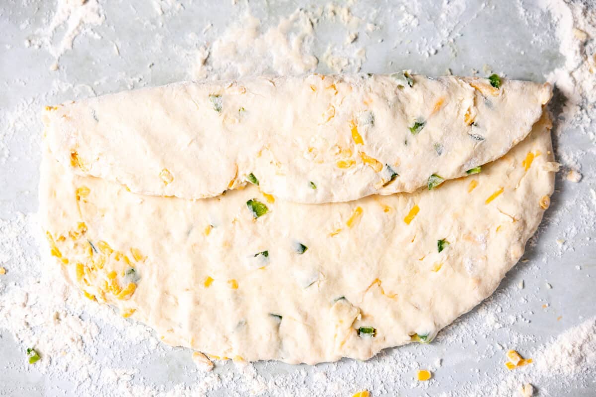 Folding biscuit dough to create flaky layers. 