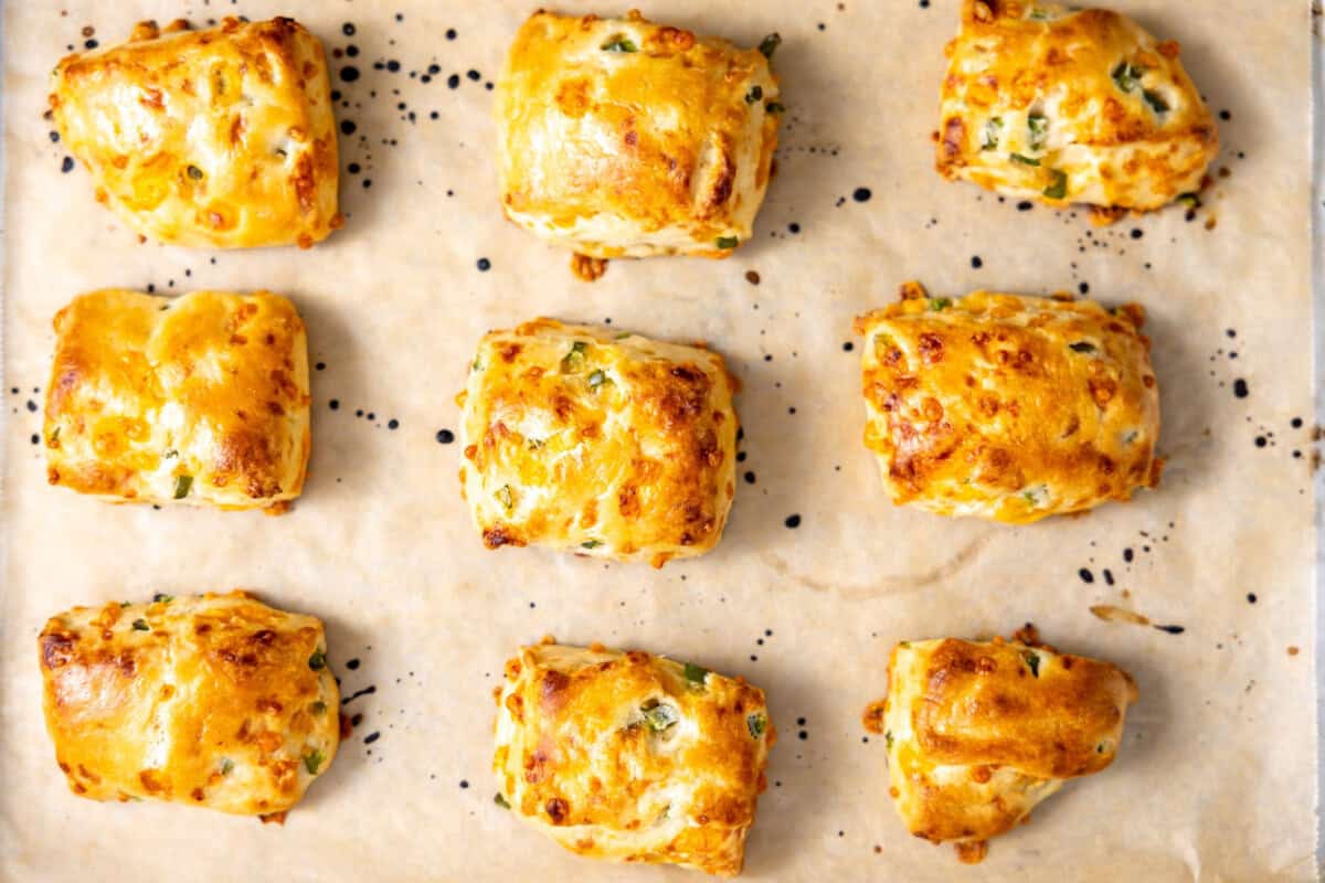 Baked jalapeno cheddar biscuits on a baking sheet. 