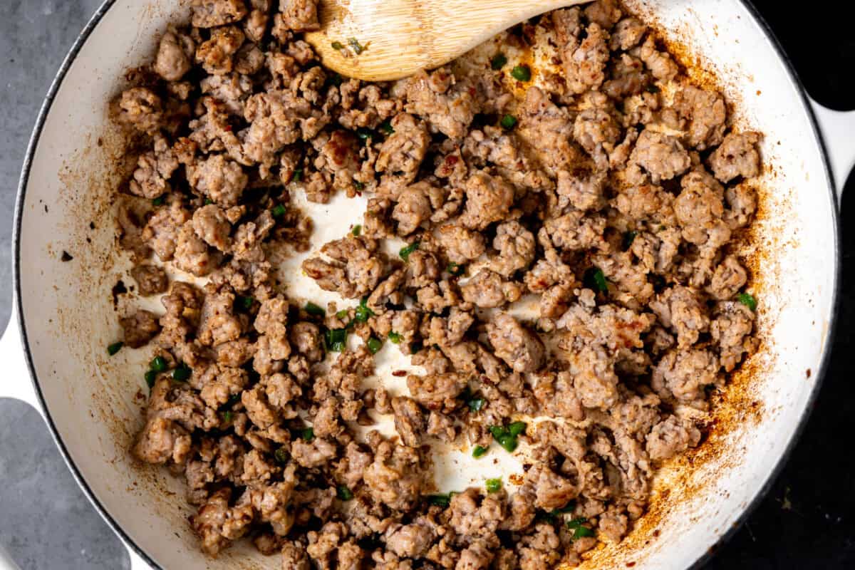 Sausage cooked with jalapeno in a skillet. 