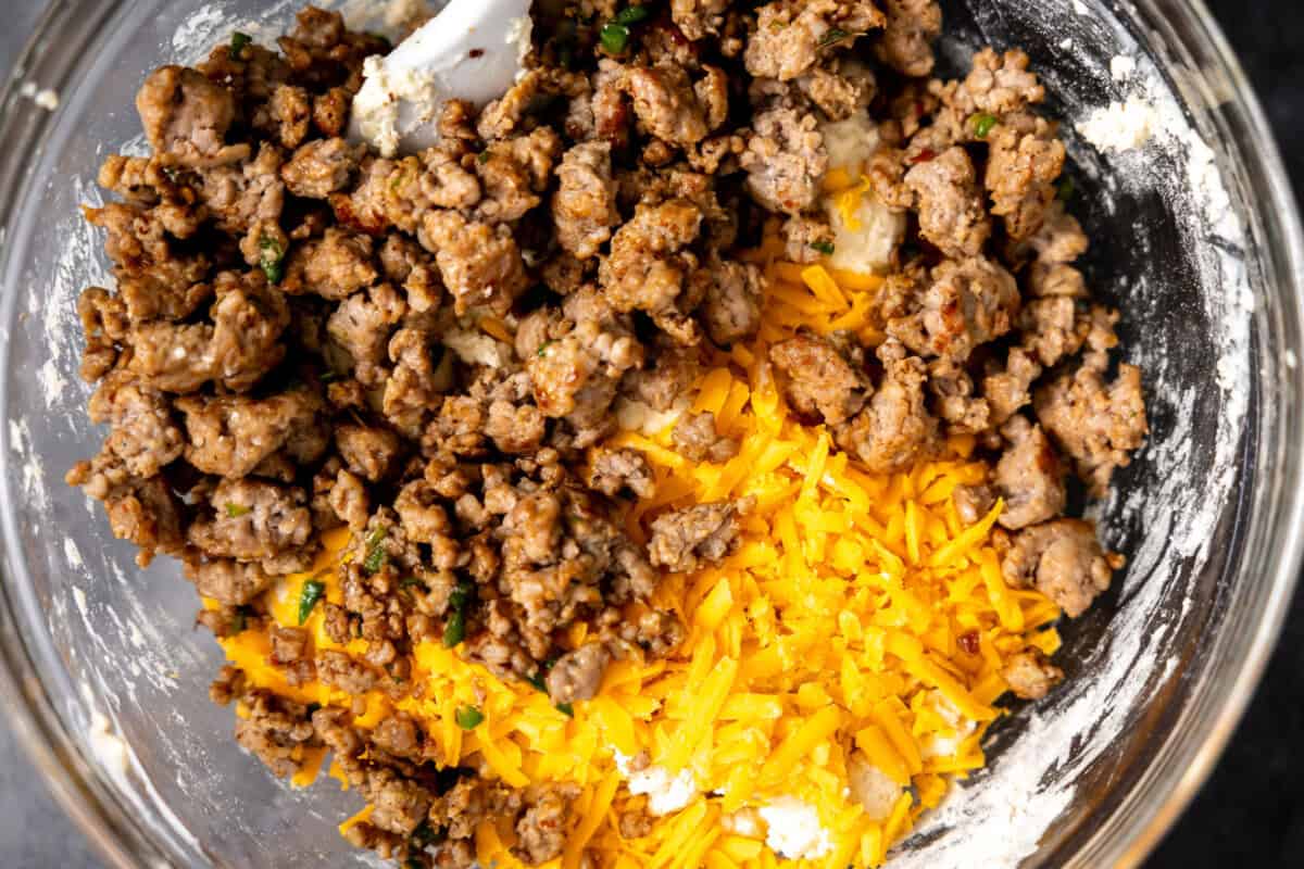 Sausage and cheese added to the dry ingredients to make a batter for biscuits. 