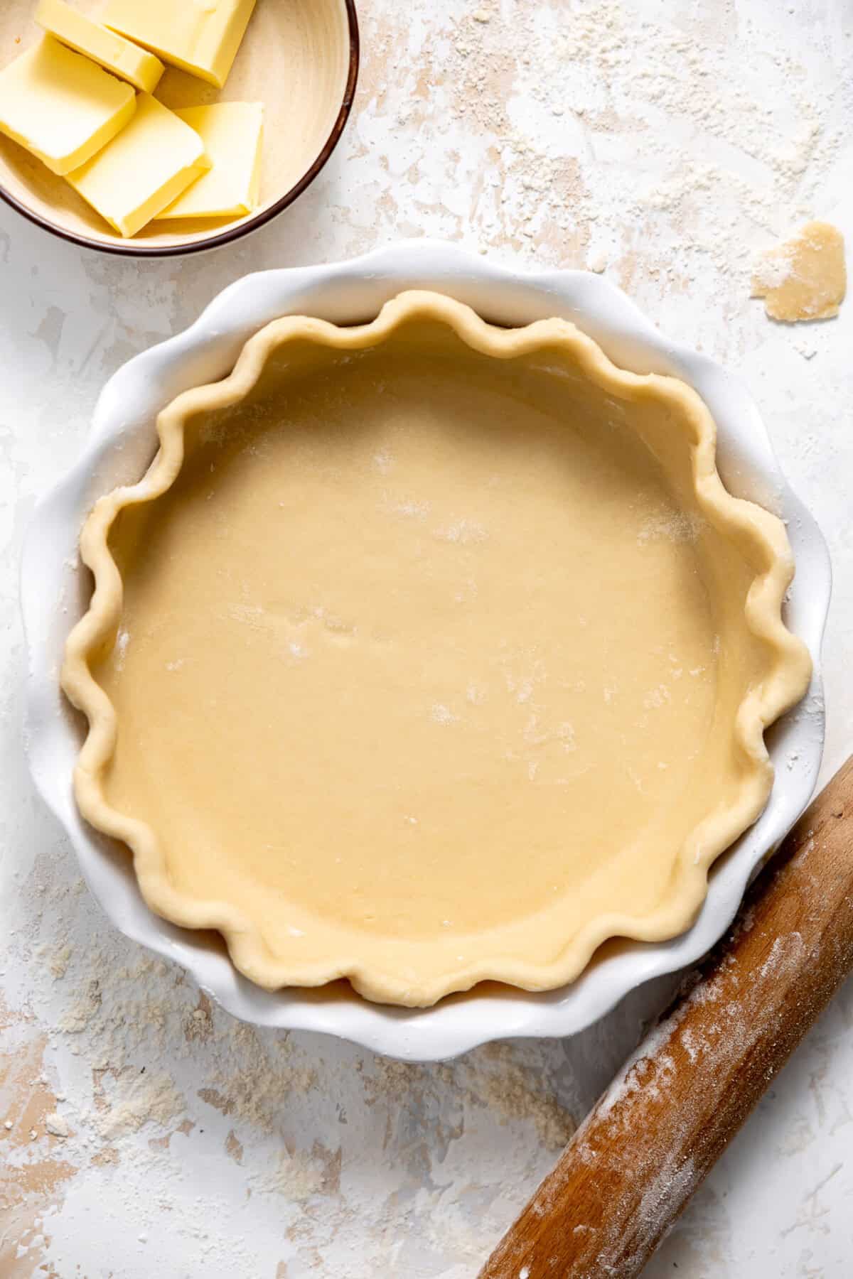 Pie crust in a white ceramic pie dish. 