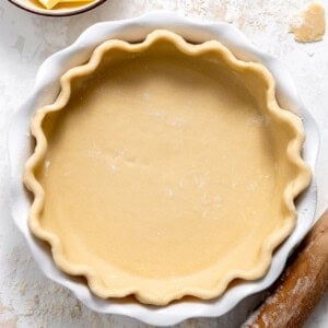 Pie crust in a white ceramic pie dish.