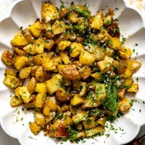 Herb Roasted Potato Salad in a white serving bowl.