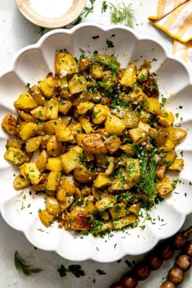 Herb Roasted Potato Salad in a white serving bowl.