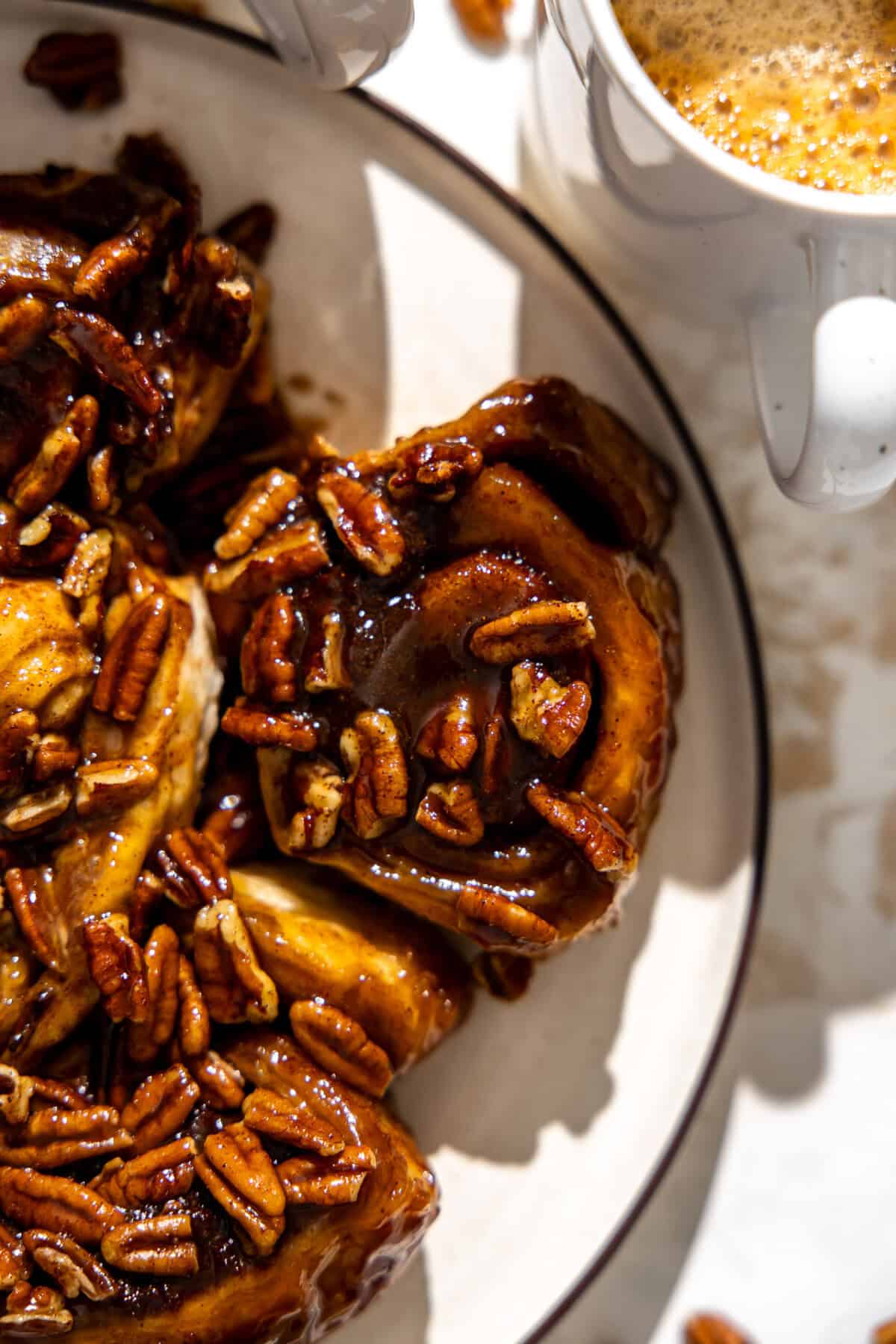 Easy sticky buns on a plate served with coffee on the side. 