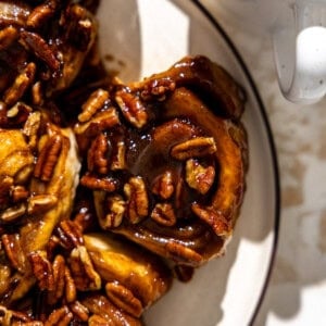 Easy sticky buns on a plate served with coffee on the side.