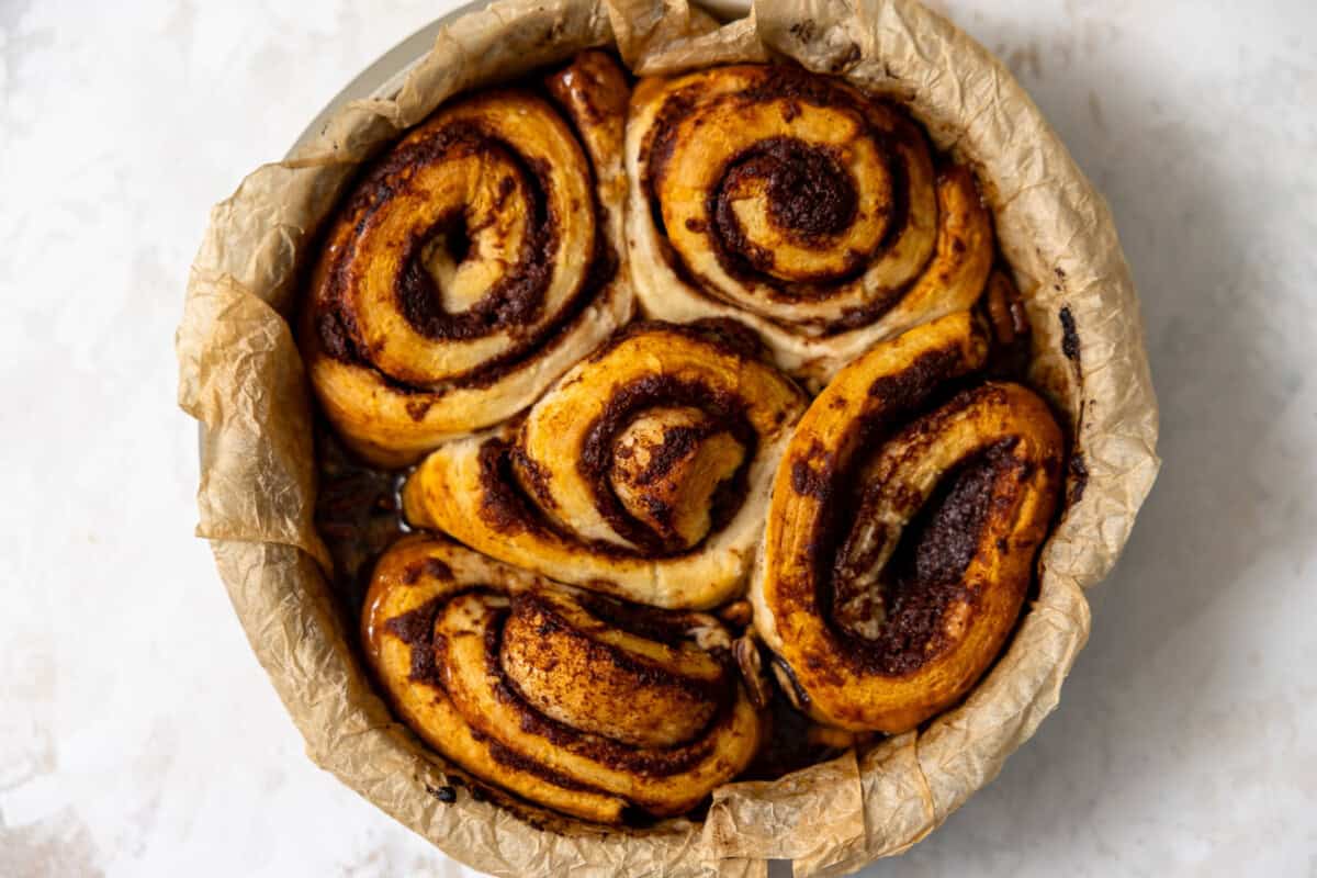 Baked sticky buns in a parchment lined baking dish.