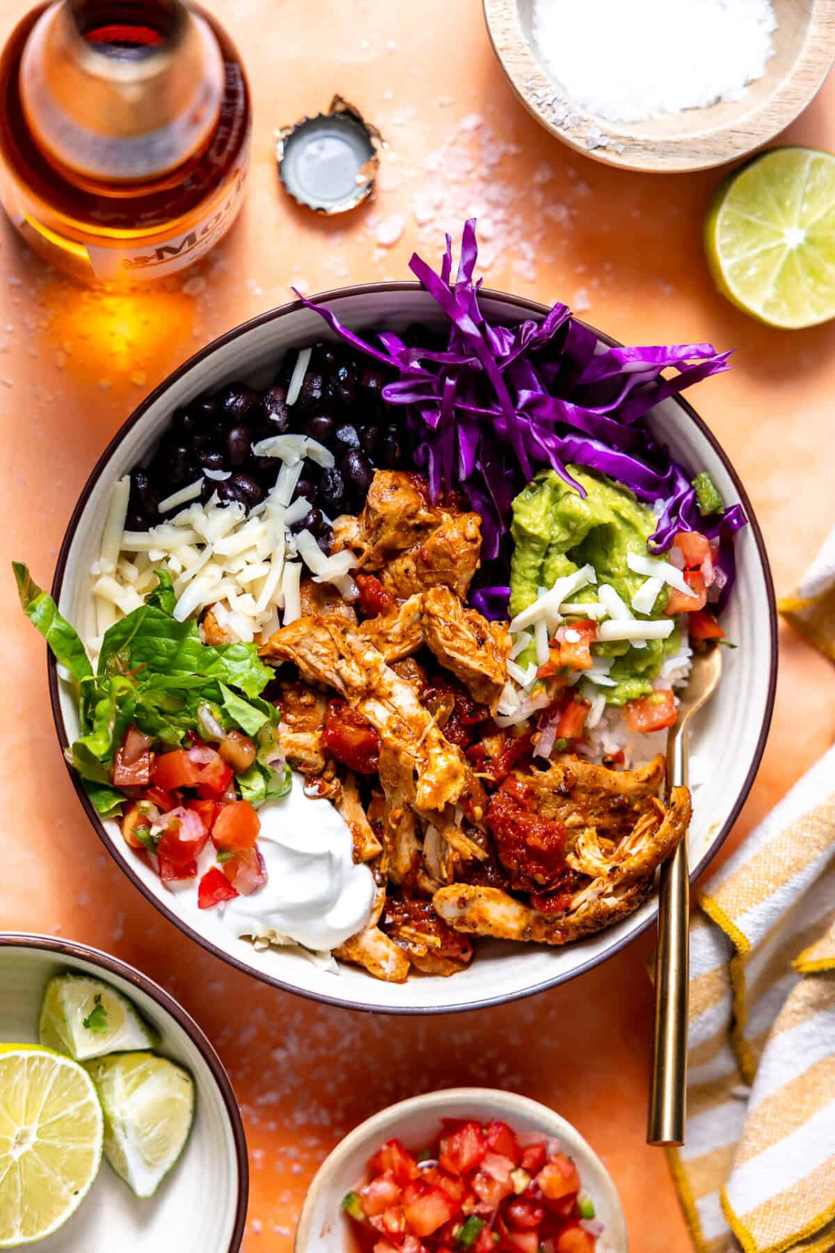 Cantina Chicken Bowls with slow roasted chicken, rice, lettuce, cabbage, pico, guacamole, and black beans. 