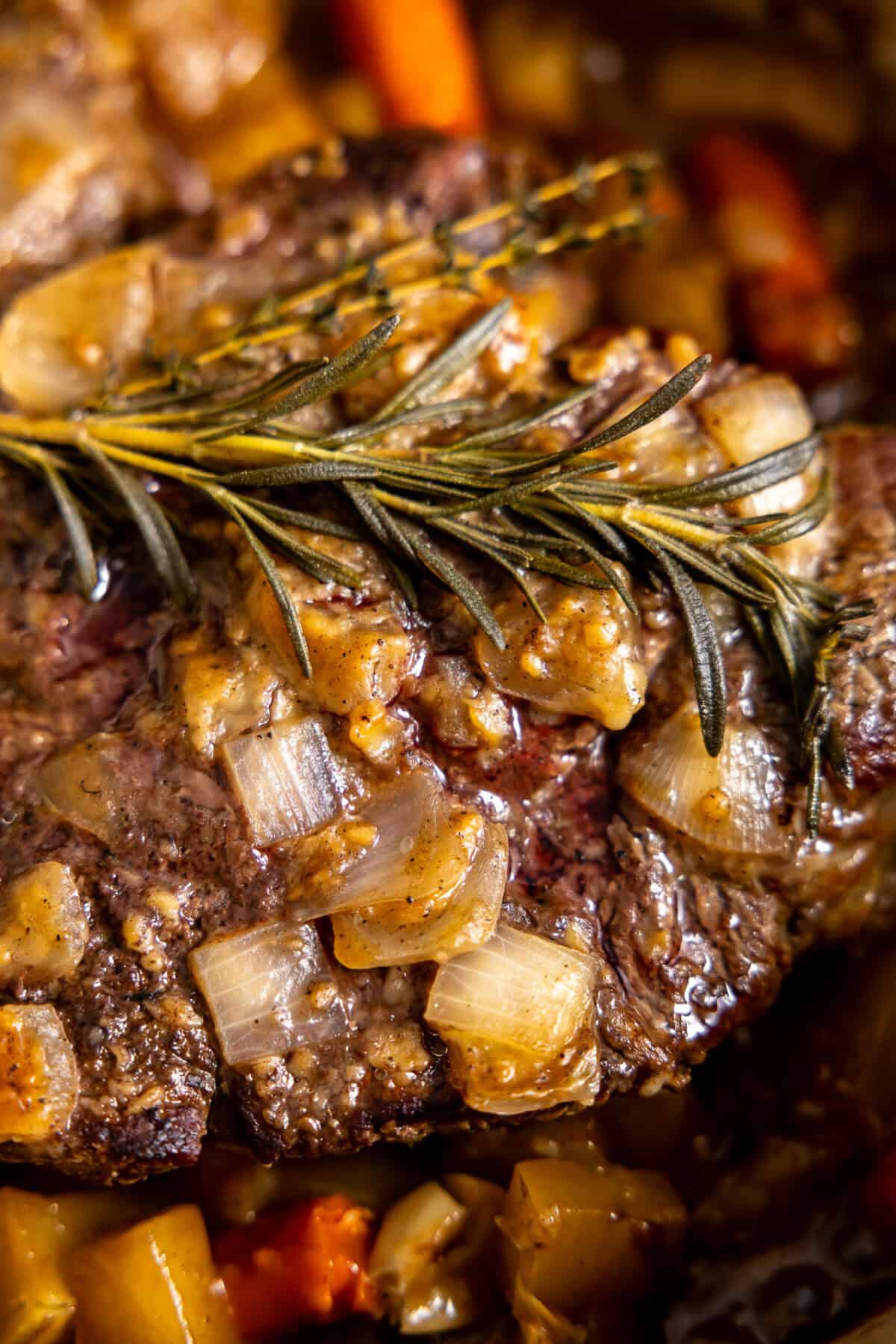 Cooked pot roast topped with herbs. 