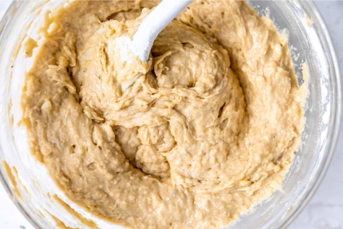 Banana bread batter in a mixing bowl. 