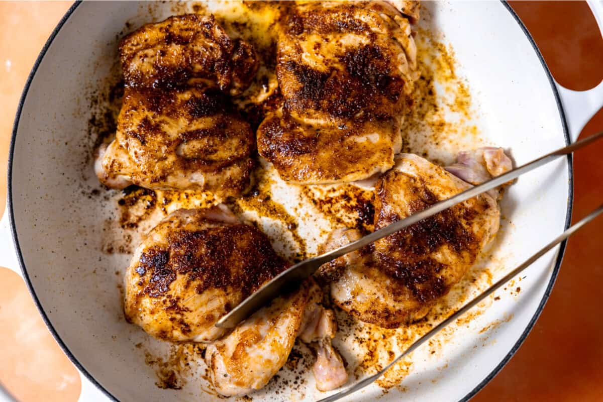 Seared chicken thighs in a skillet. 