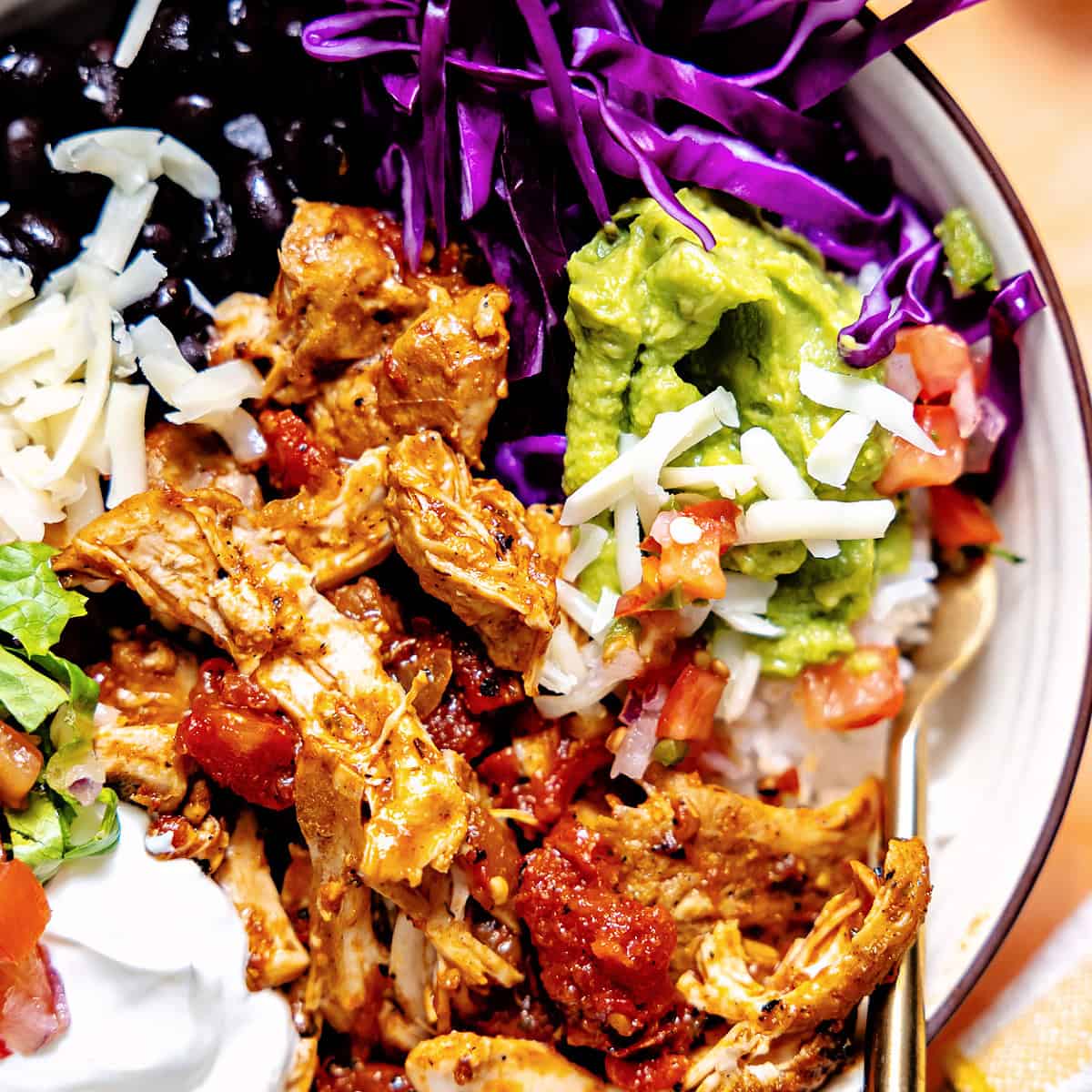 Cantina chicken layered in a bowl with other ingredients to make a meal.