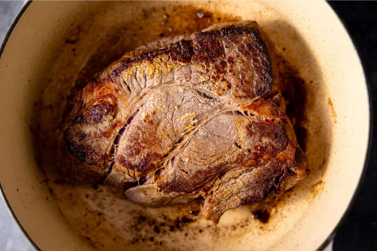 Searing chuck roast in a dutch oven for making pot roast. 