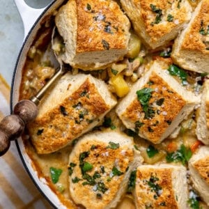 Chicken pot pie with biscuits that have a homemade garlic herb butter brushed on top.