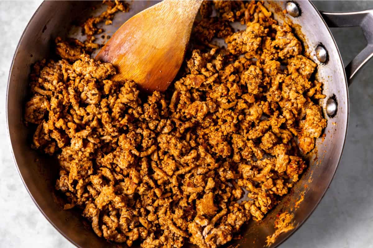 Cooked ground turkey with taco seasoning in a skillet. 