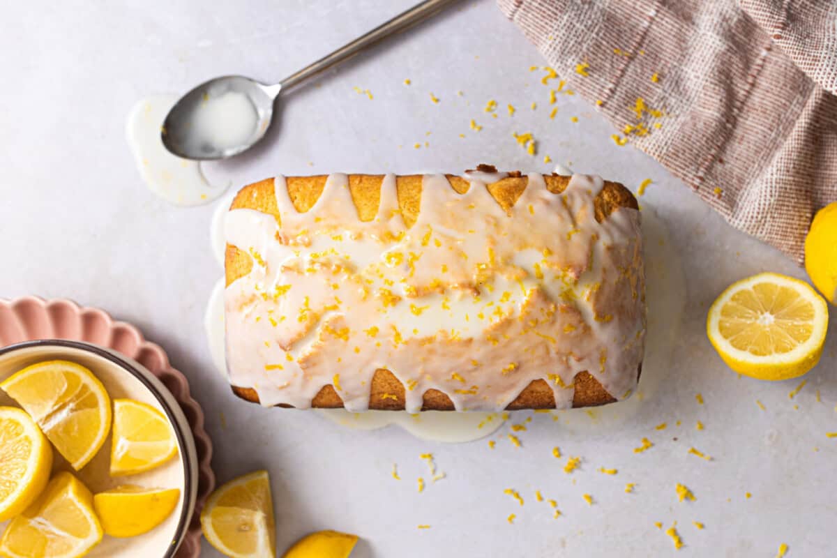 Glaze poured on top of a loaf cake.