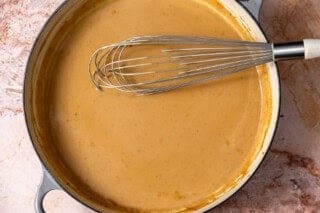 Swedish meatball gravy cooking in a skillet.