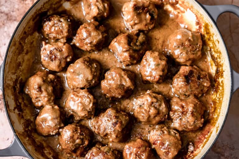 Swedish meatballs in a skillet with creamy gravy.