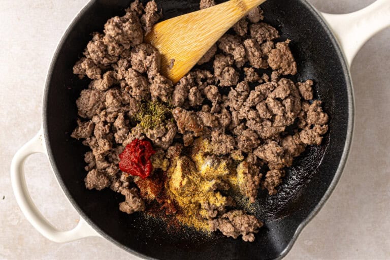 Ground beef with seasonings in a skillet.