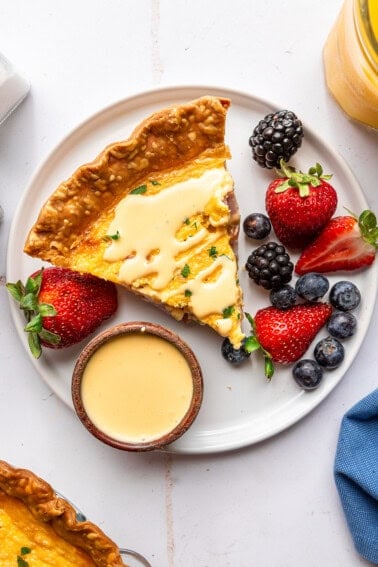 Quiche served with hollandaise and berries.