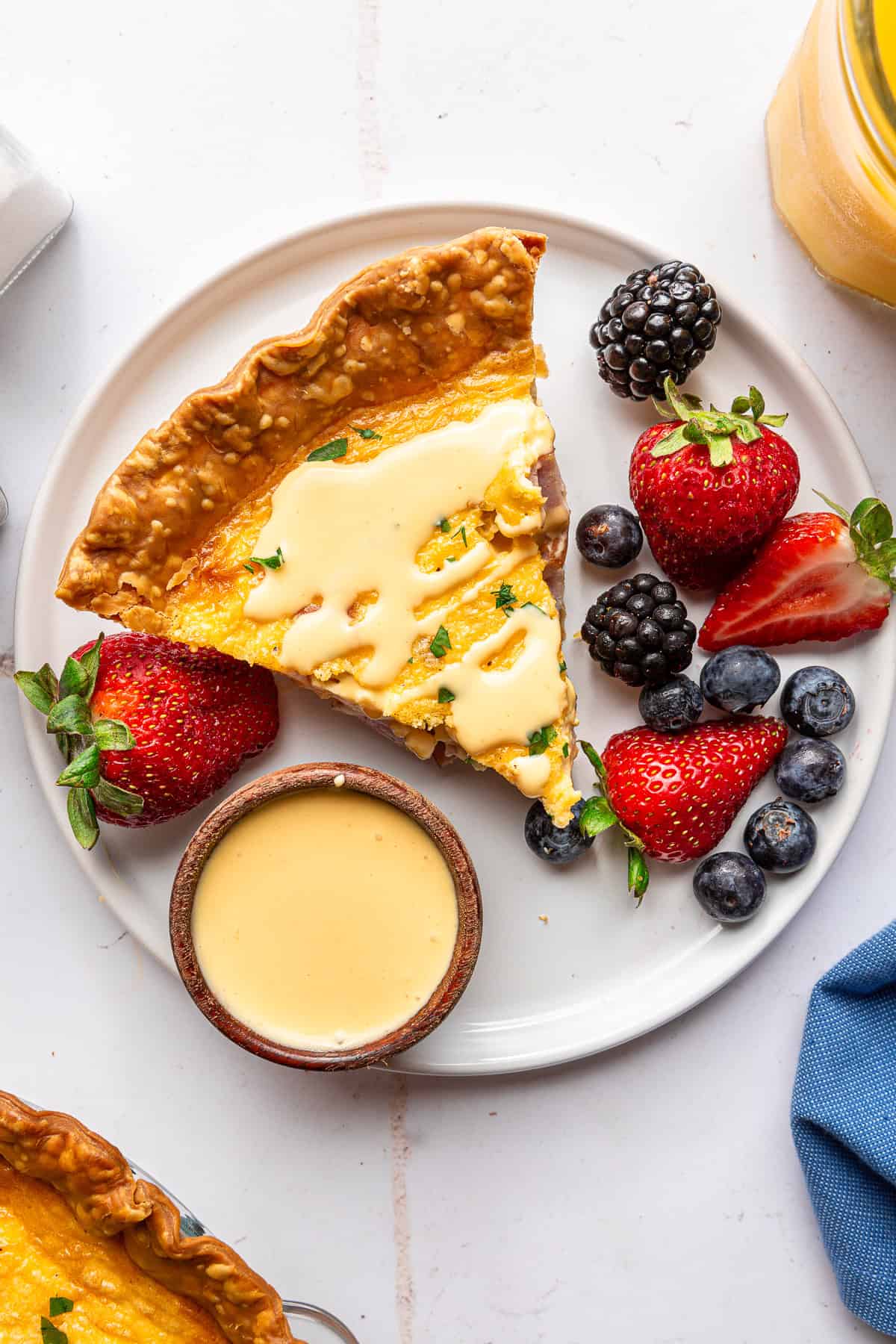 Quiche served with hollandaise and berries.