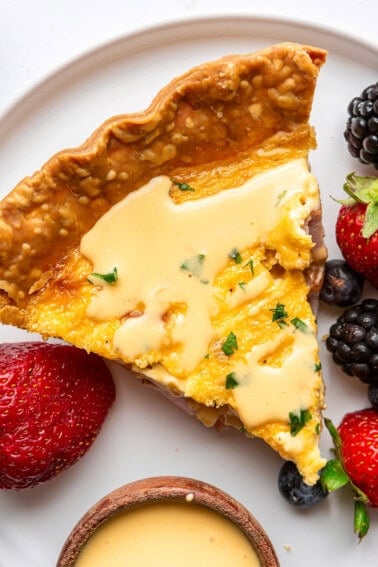 Eggs Benedict Quiche served with hollandaise sauce on top.