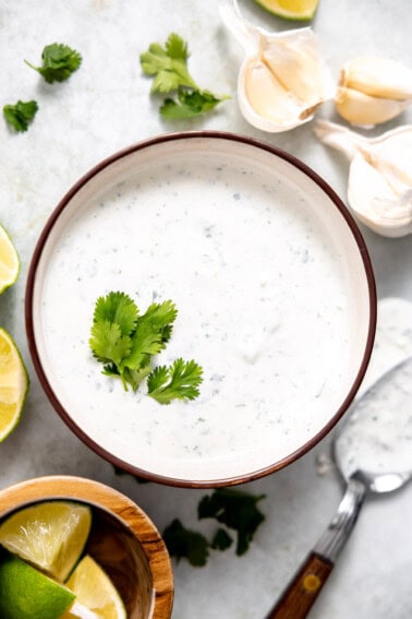 Bowl of cilantro lime sauce topped with fresh cilantro.