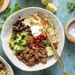 Ground beef burrito bowls served with lime on the side.